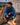 man wearing a blanket with a s'more in hand #color_blue